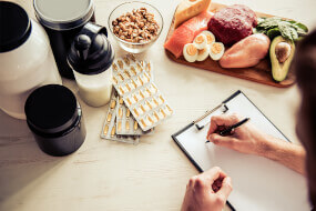 Notepad, healthy food, protein powder, and health supplements