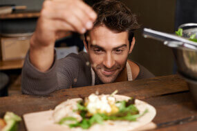 Man seasoning a plate of food