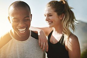 Two friends laughing after a run