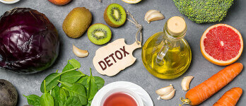 Flatlay of healthy vegetables, fruits and olive oil on a table with detox lable Flatlay of healthy vegetables, fruits and olive oil on a table with detox lable